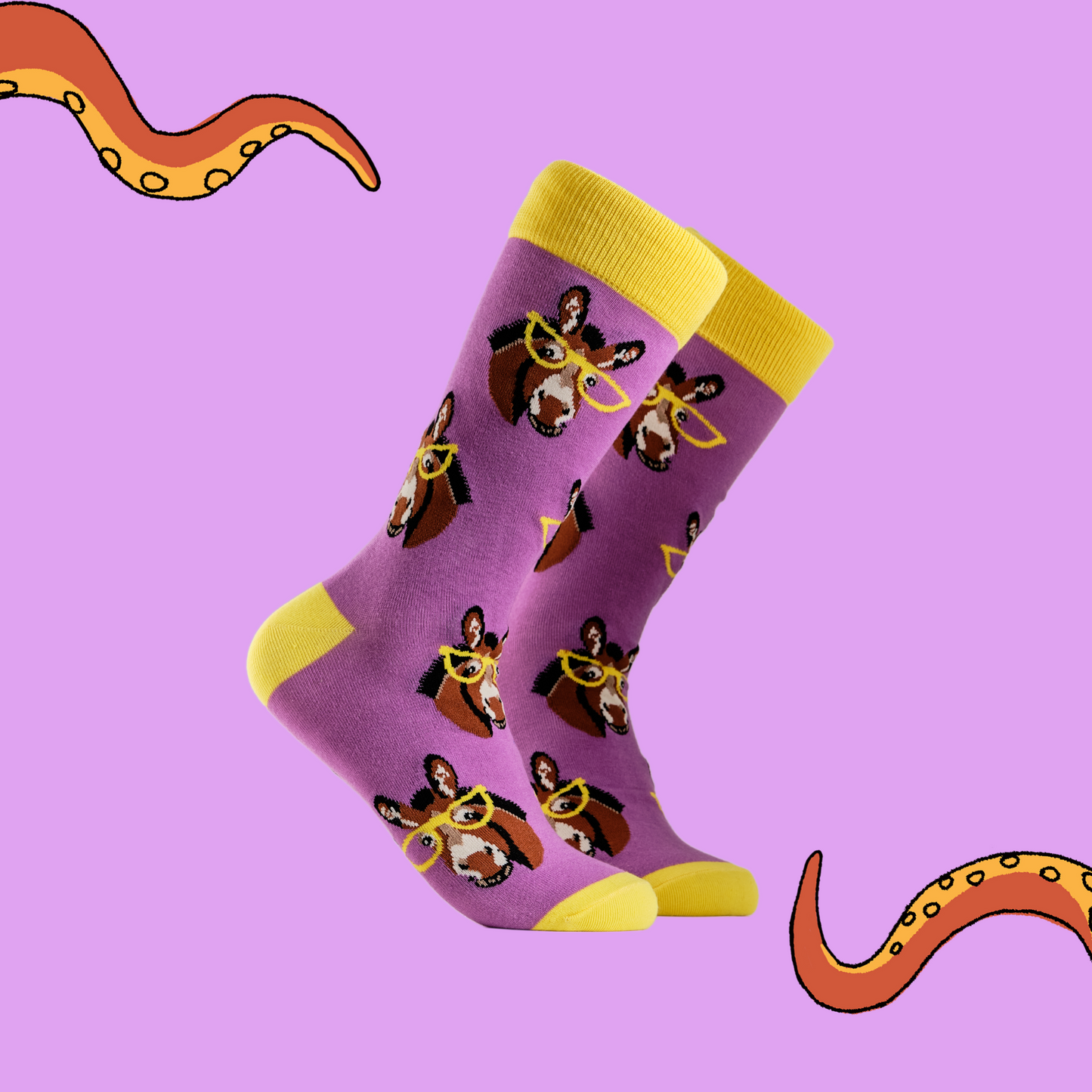 
                  
                    A pair of socks depicting donkeys wearing glasses. Bright pink legs, yellow cuff, heel and toe.
                  
                