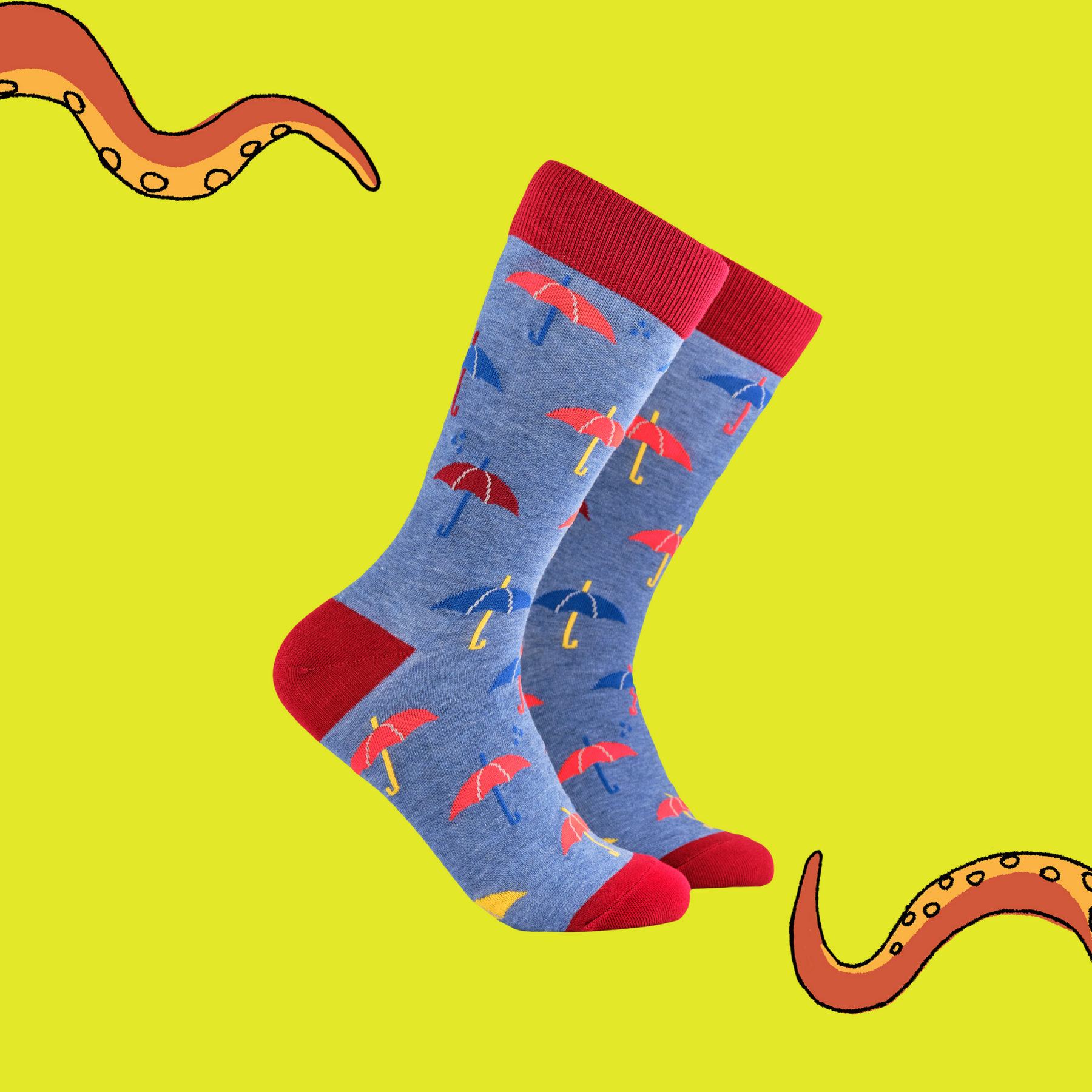 A pair of socks depicting red and blue umbrellas. Blue legs, red cuff, heel and toe.