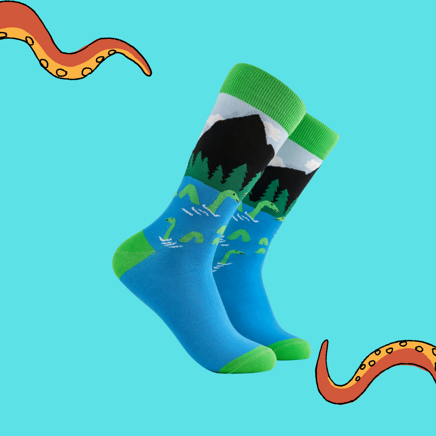 A pair of socks depicting the loch ness monster. Blue legs, green cuff, heel and toe.