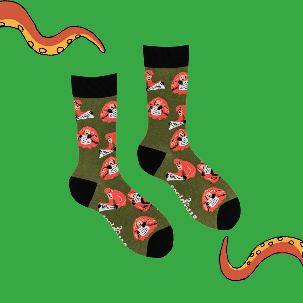 
                  
                    A pair of socks depicting clever Orangutans. Green legs, black cuff, heel and toe.
                  
                