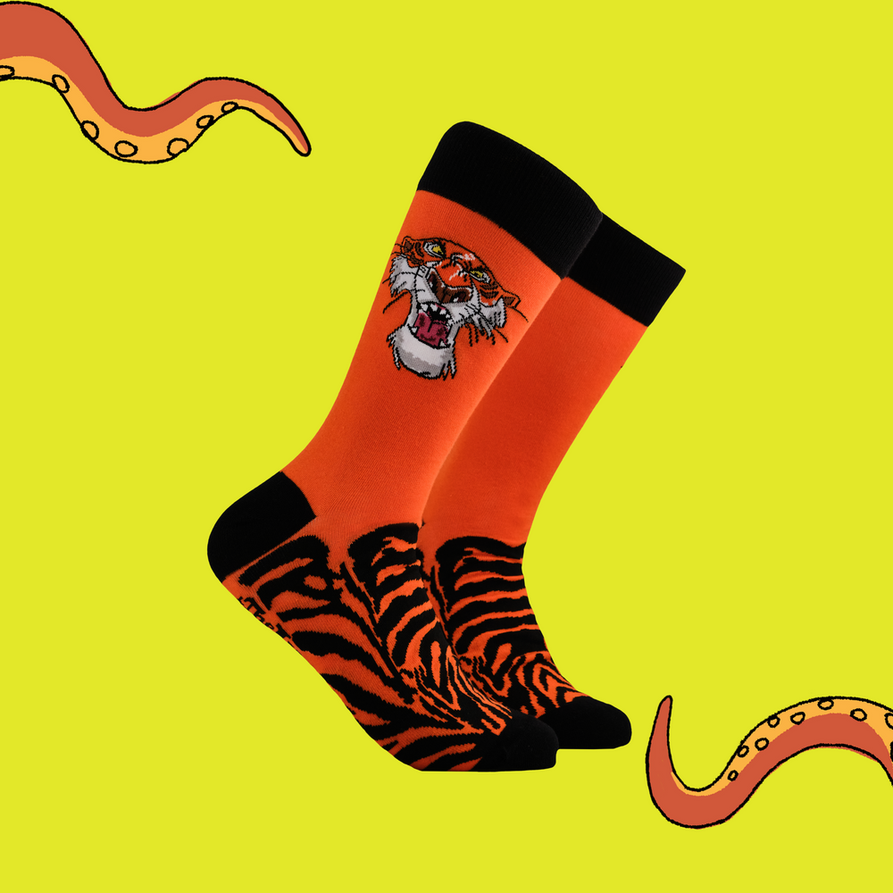 
                      
                        A pair of socks depicting the villain of Jungle Book. Shere Khan. Orange legs, black toes, cuffs and heel.
                      
                    