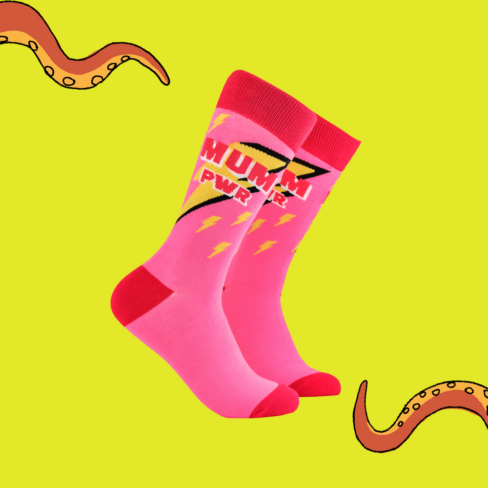A pair of socks depicting lightning bolts and the words MUM PWR. Pink legs, red cuff, heel and toe.