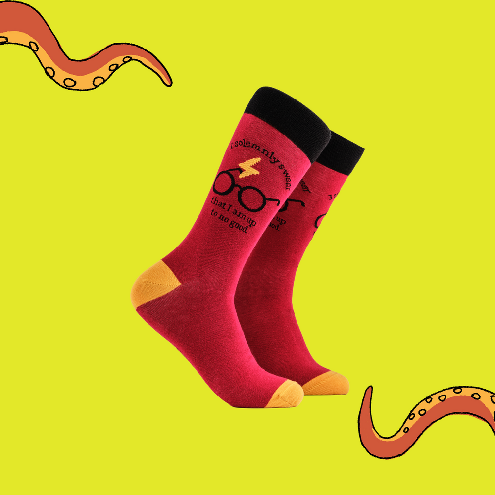 A pair of socks depicting Harry Potter glasses. Red legs, black cuff, yellow heel and toe.