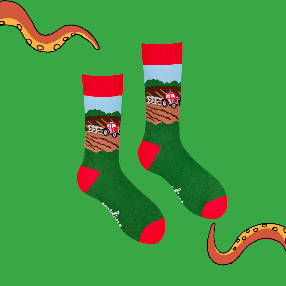 
                  
                    A pair of socks depicting farm life and tractor plowing the field.. Green legs, red cuff, heel and toe.
                  
                