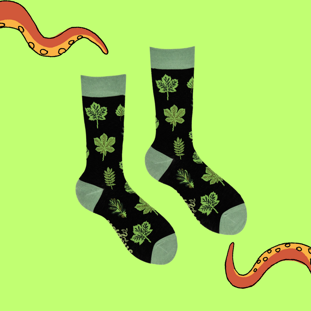 
                  
                    A pair of socks depicting bamboo leaves. Black legs, light green cuff, heel and toe.
                  
                