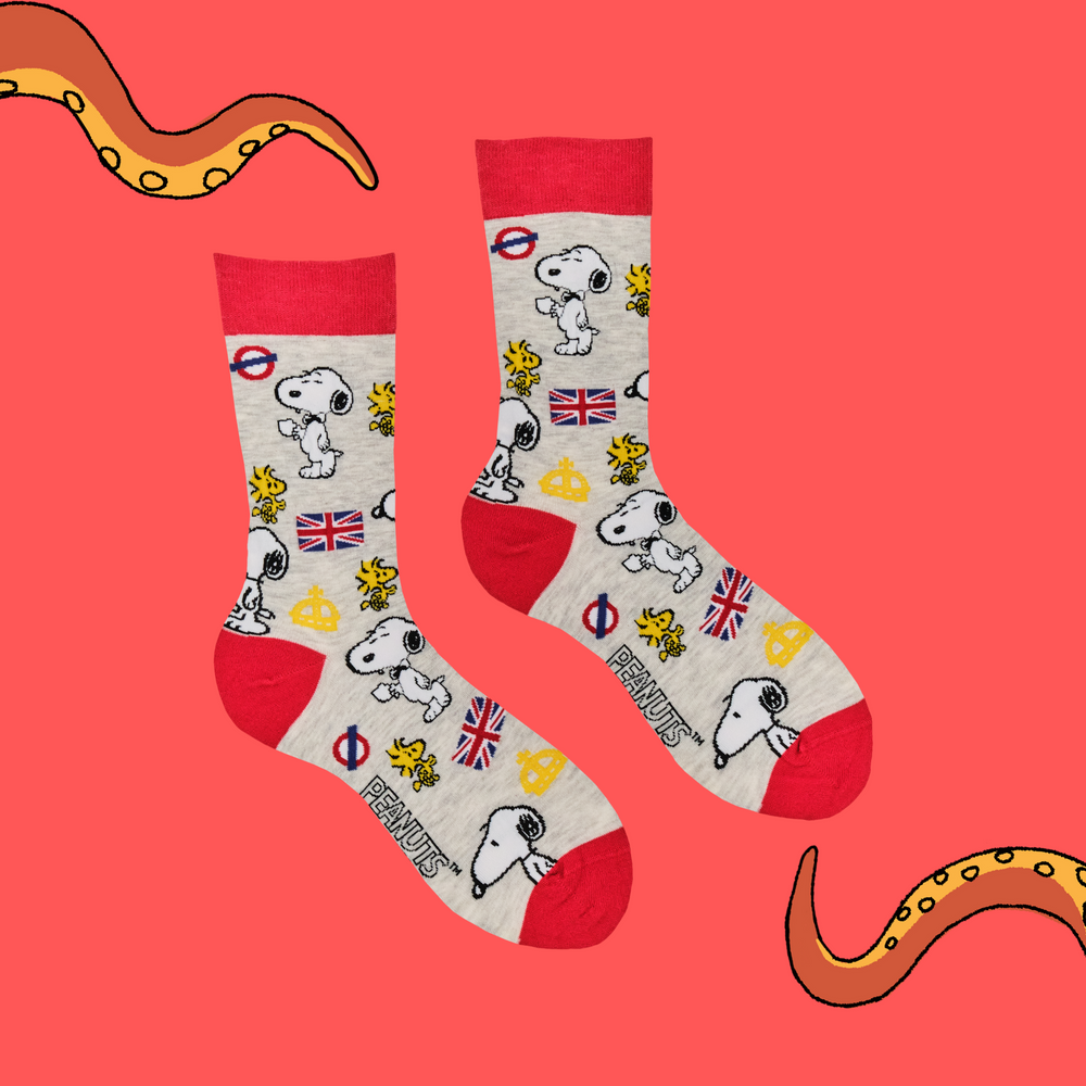 
                      
                         A pair of socks depicting Snoopy and Woodstock with a London motif. Grey legs, red cuff, toe and heel. 
                      
                    