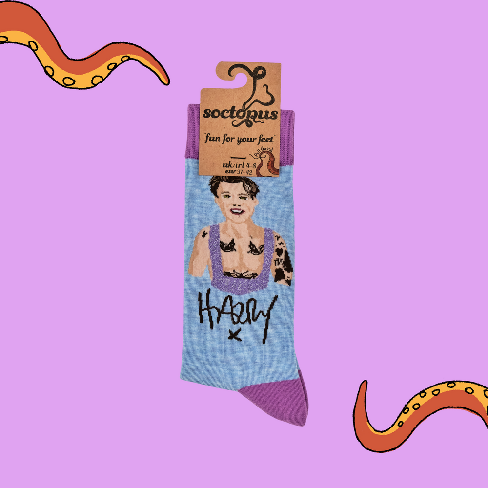 
                      
                        A pair of socks depicting Harry Styles. Blue legs, purple toe, heel and cuff. 
                      
                    