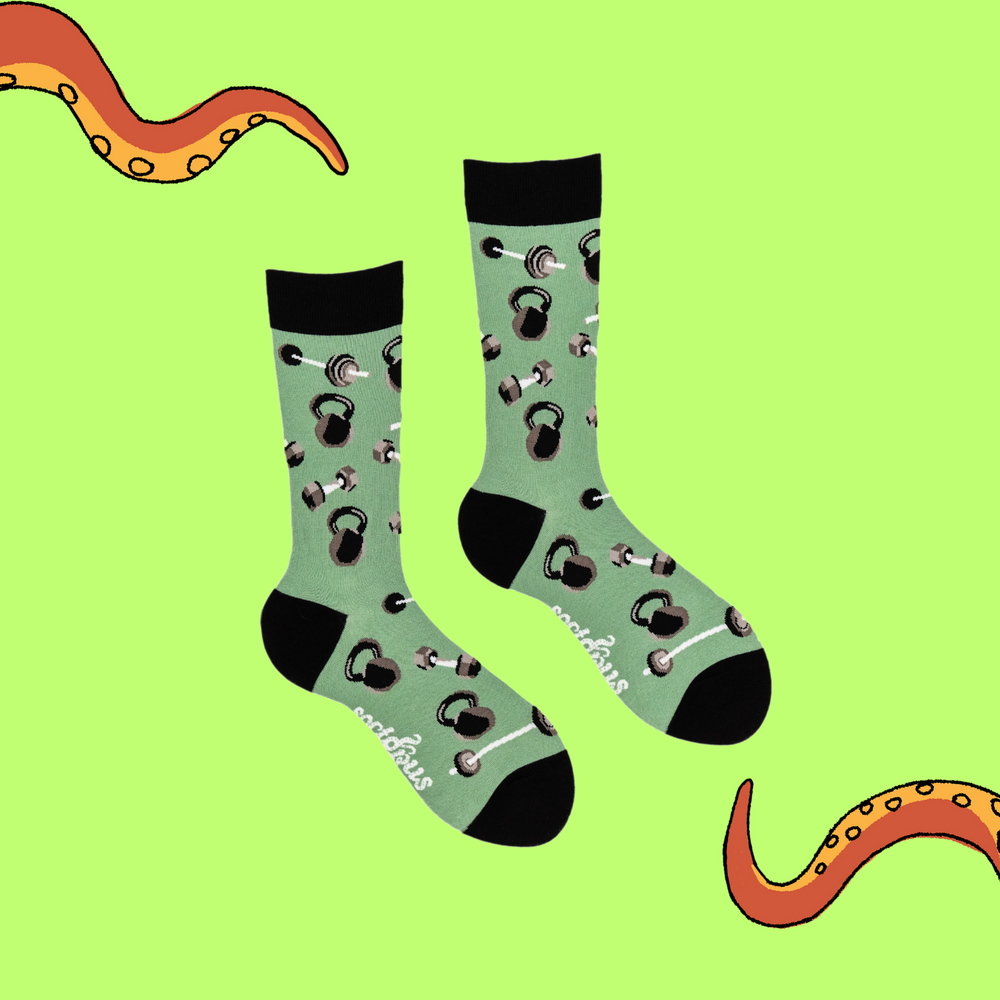 
                      
                        A pair of socks depicting dumb bells and kettle bells. Green legs, black cuff, heel and toe.
                      
                    