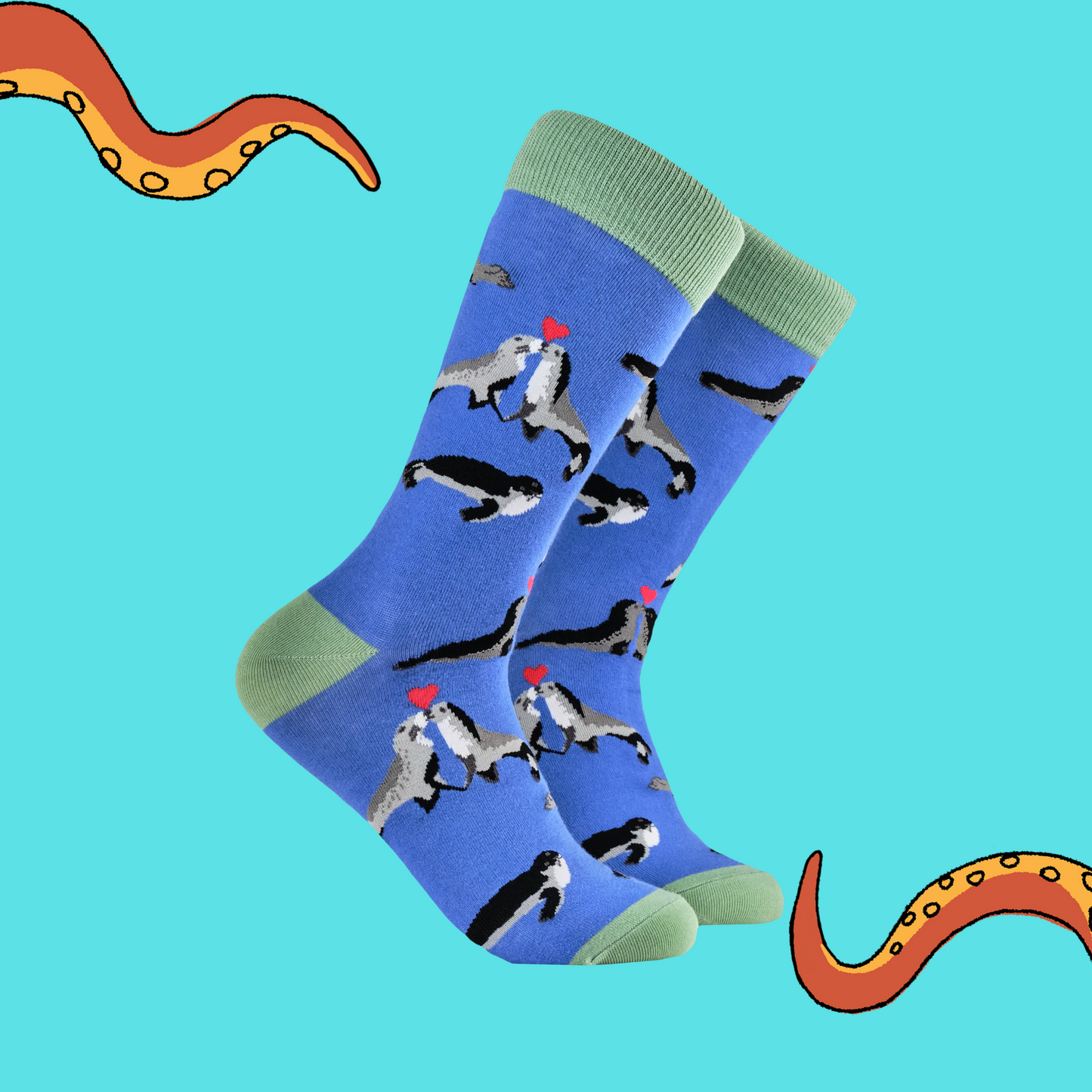 A pair of socks depicting two seals in love. Blue legs, green heel, toe and cuff. 