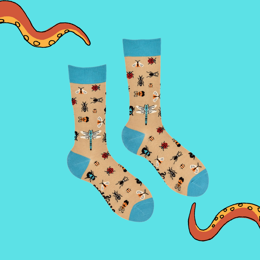 
                      
                        A pair of socks depicting insect wildelife. Beige legs, blue cuff, heel and toe.
                      
                    