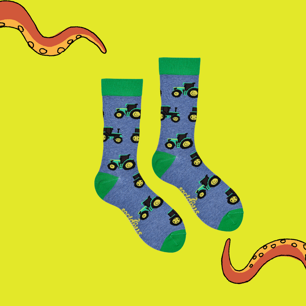 
                  
                    A pair of socks depicting green tractors. Blue legs, green cuff, heel and toe.
                  
                