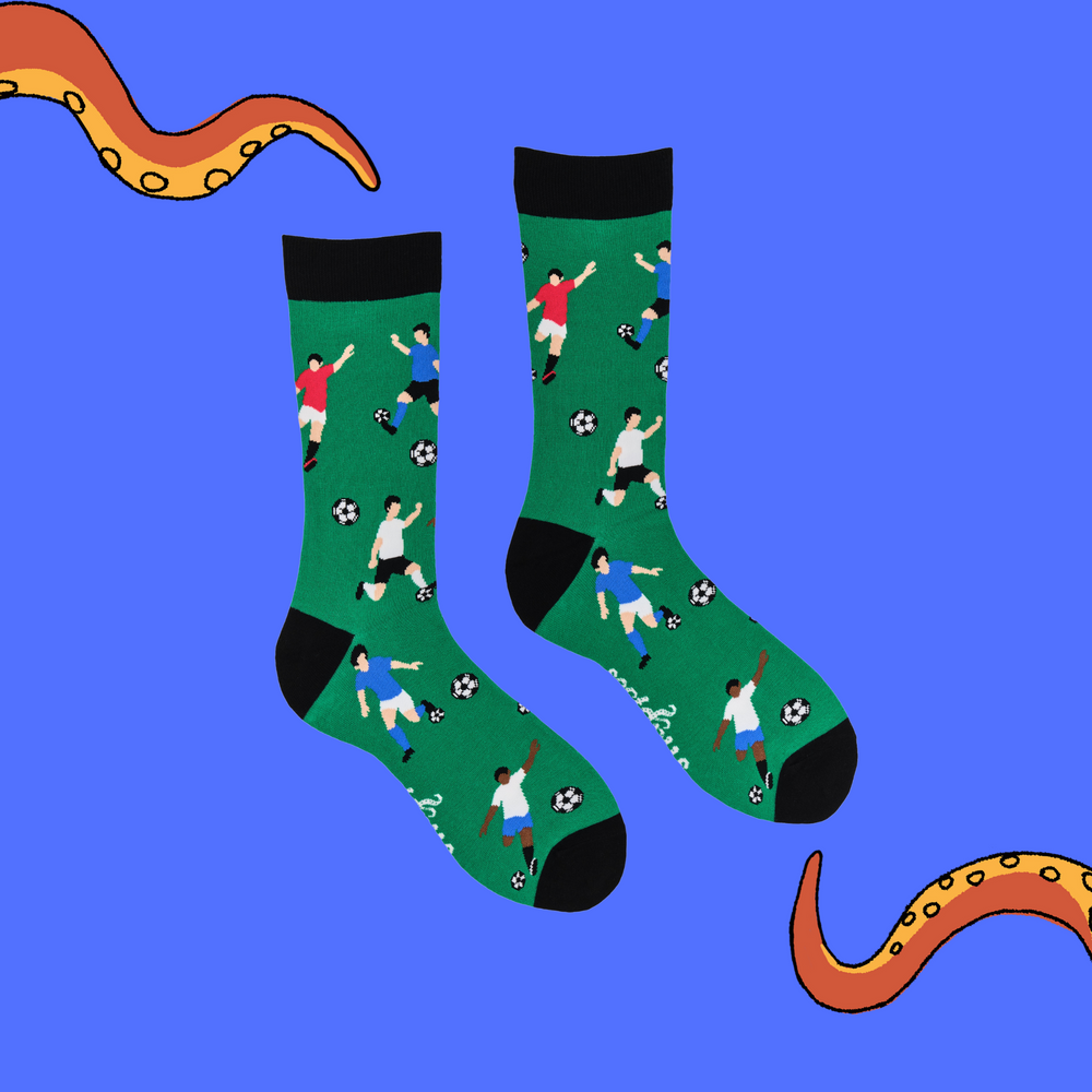 
                  
                    A pair of socks depicting footballers. Green legs, black cuff, heel and toe.
                  
                