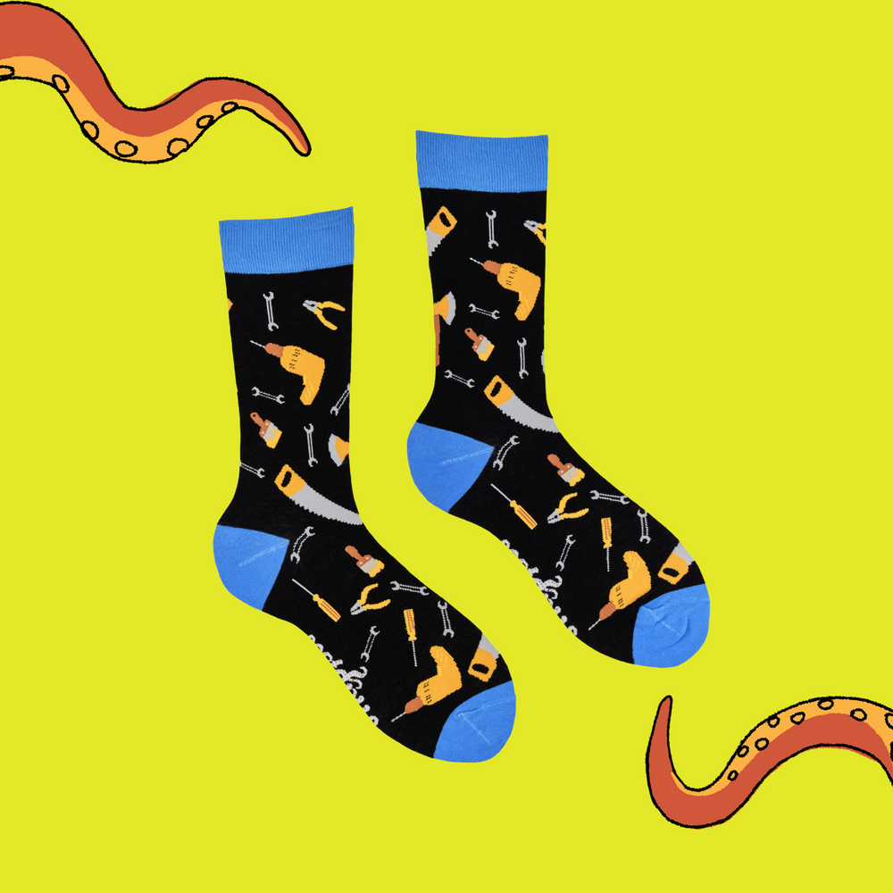 
                      
                        A pair of socks depicting DIY tools. Black legs, blue cuff, heel and toe.
                      
                    