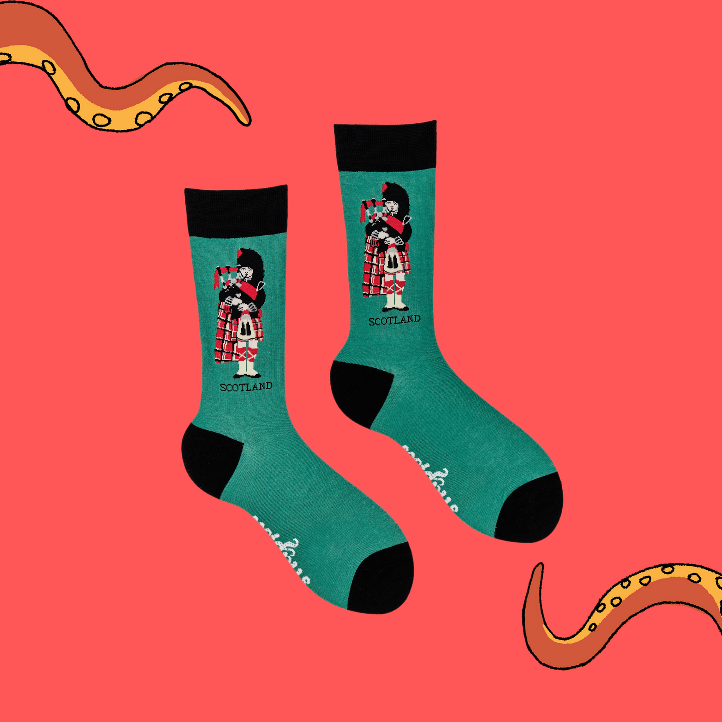 
                  
                    A pair of socks depicting a scotsman playing bag pipes. Green legs, black cuff, heel and toe.
                  
                