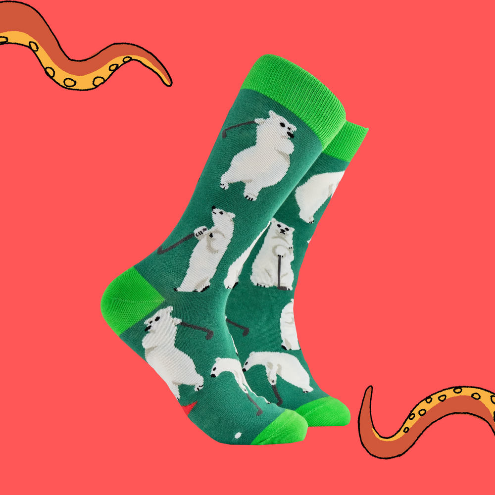 A pair of socks depicting a polar bear playing golf. Dark green legs, bright green heel, toe and cuff. 