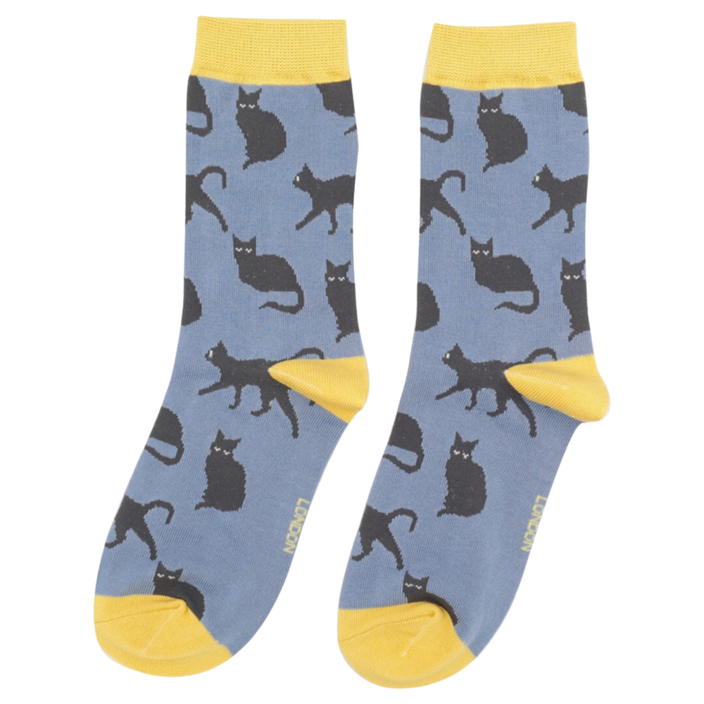 
                  
                    A pair of socks depicting cute black cats. Blue legs, yellow toe, cuff and heel.
                  
                