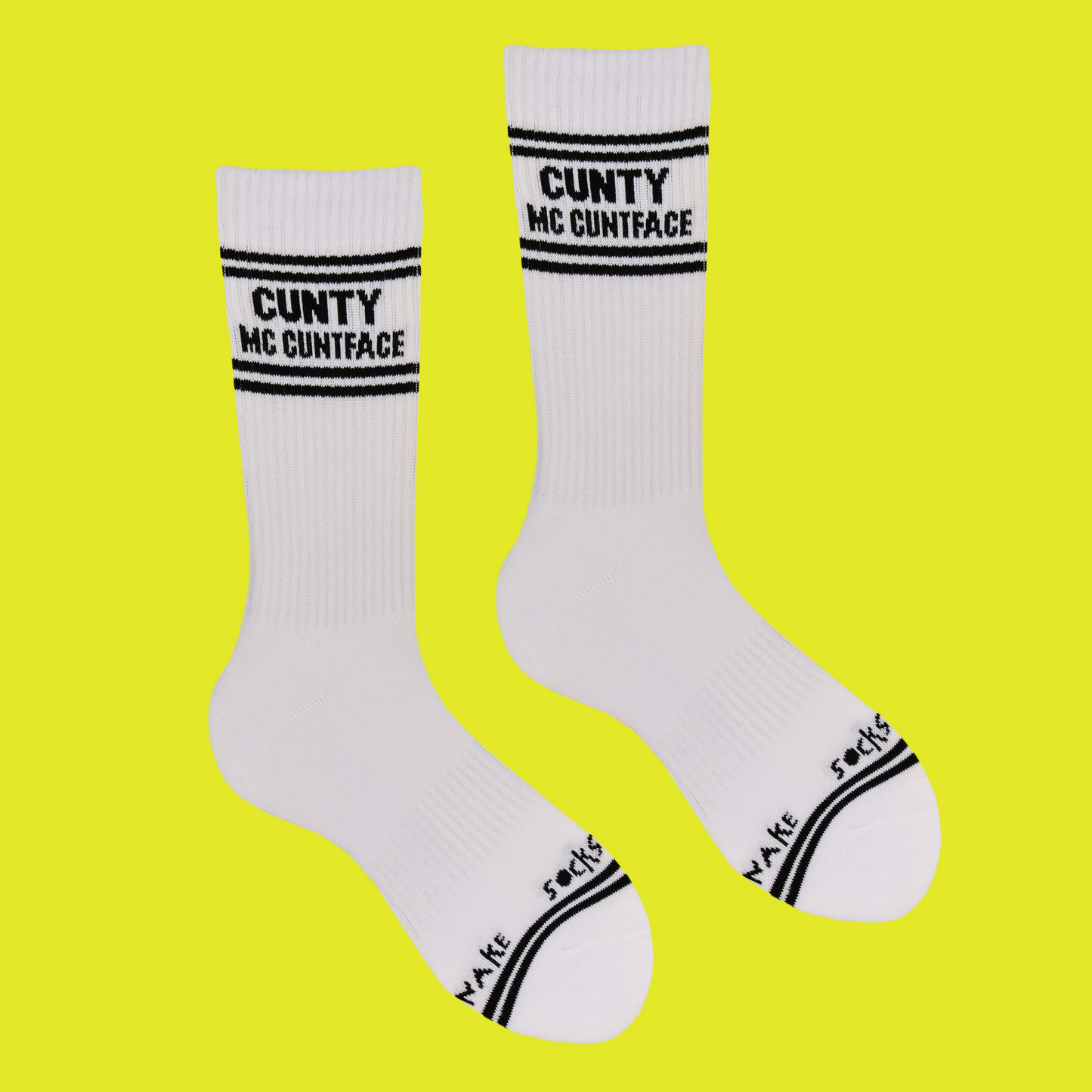 
                  
                    A white pair of athletic socks with black trim on the ankles and toes. With some very rude words on the ankle.
                  
                