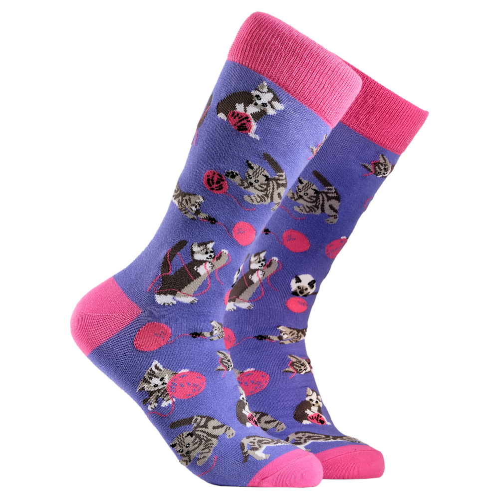 Cats and Wool Socks. A pair of socks depicting cats playing with wool. Purple legs, pink cuff, heel and toe.