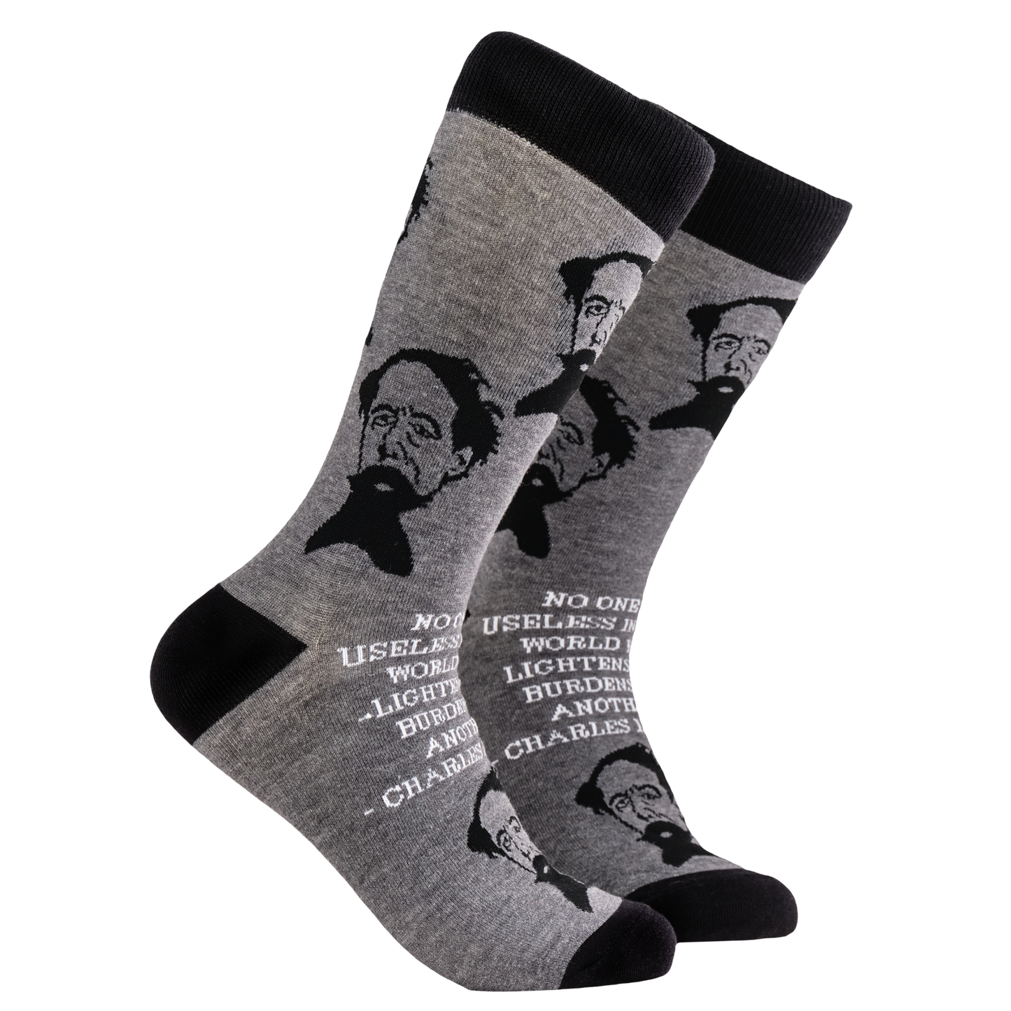 
                  
                    Charles Dickens Socks. A pair of socks depicting Charles Dickens and a quote. Grey legs, black cuff, heel and toe.
                  
                