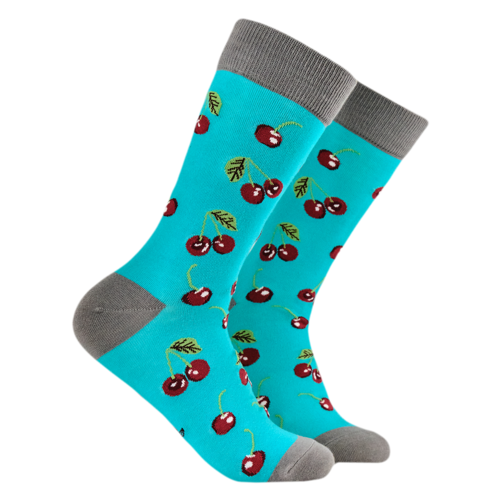 
                      
                        A pair of socks featuring cherries. Bright blue legs, grey heel, toe and cuff. 
                      
                    