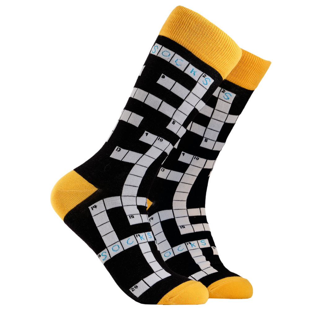 Crossword Socks. A pair of socks depicting Crosswords. Black legs, yellow cuff, heel and toe.