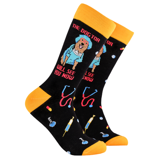 Dog Socks - The Dogtor. A pair of socks depicting a dog dressed in medical scrubs. Black legs, yellow cuff, heel and toe.