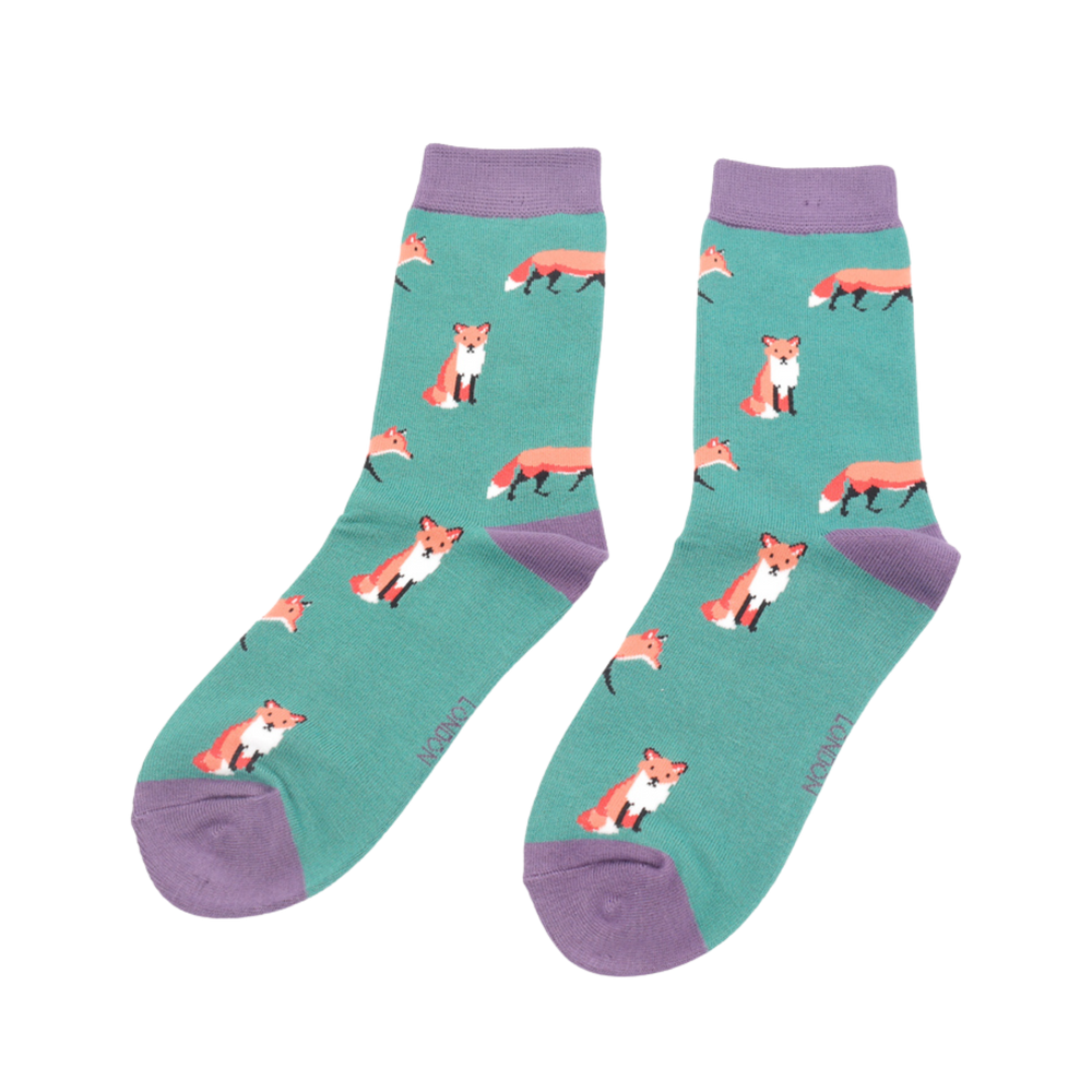 
                  
                    A pair of socks featuring a cute fox design. Light green legs, purple cuff, heel and toe.
                  
                