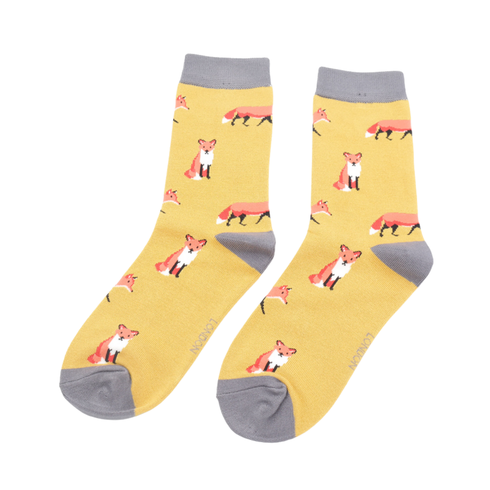 
                  
                    A pair of socks featuring a cute fox design. Yellow legs, grey cuff, heel and toe.
                  
                