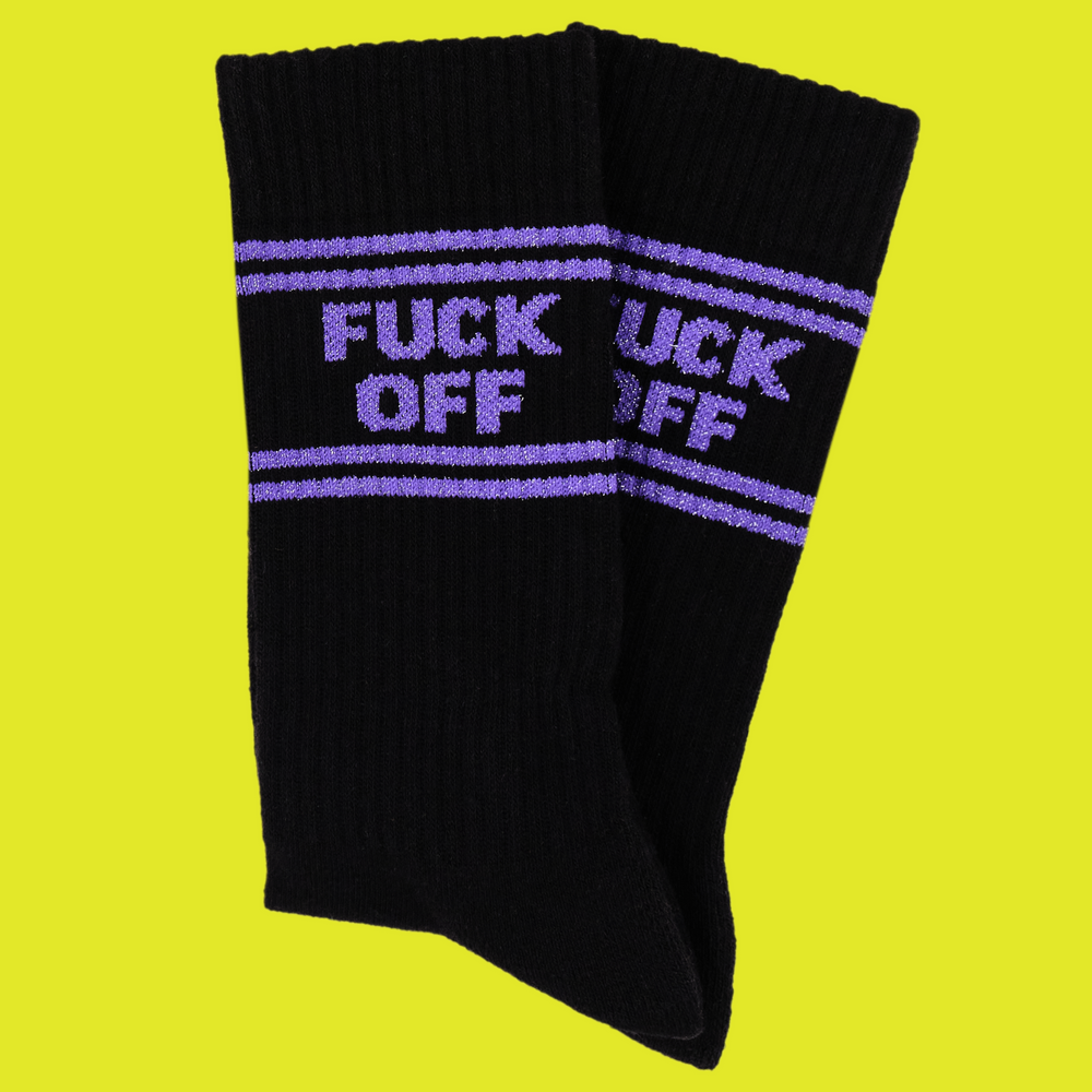 
                  
                    A black pair of athletic socks with purple trim on the ankles and toes. And some very rude words that mean get lost on the ankle.
                  
                