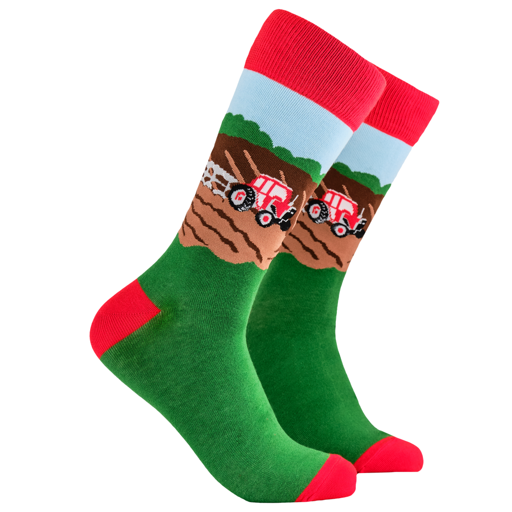 Farming Life Socks. A pair of socks depicting farm life and tractor plowing the field.. Green legs, red cuff, heel and toe.