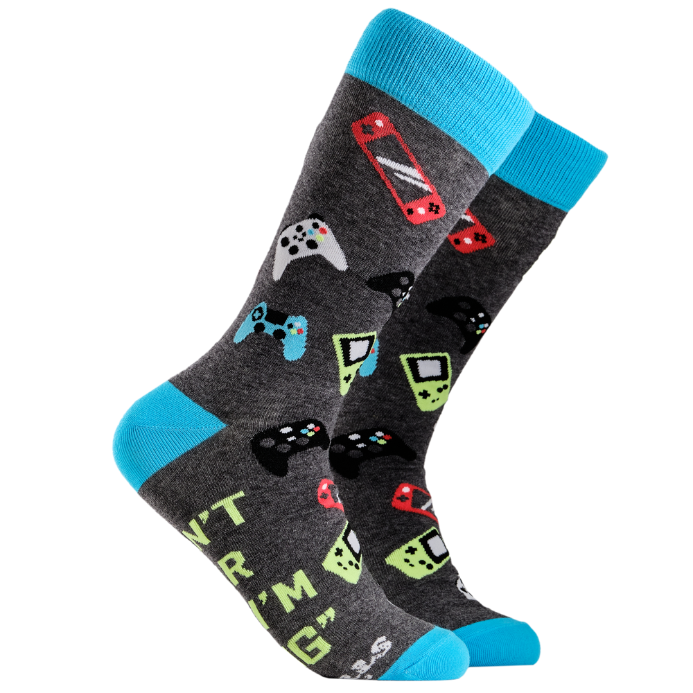 Gamer Socks. A pair of socks depicting game controllers and consoles. Grey legs, blue cuff, heel and toe.