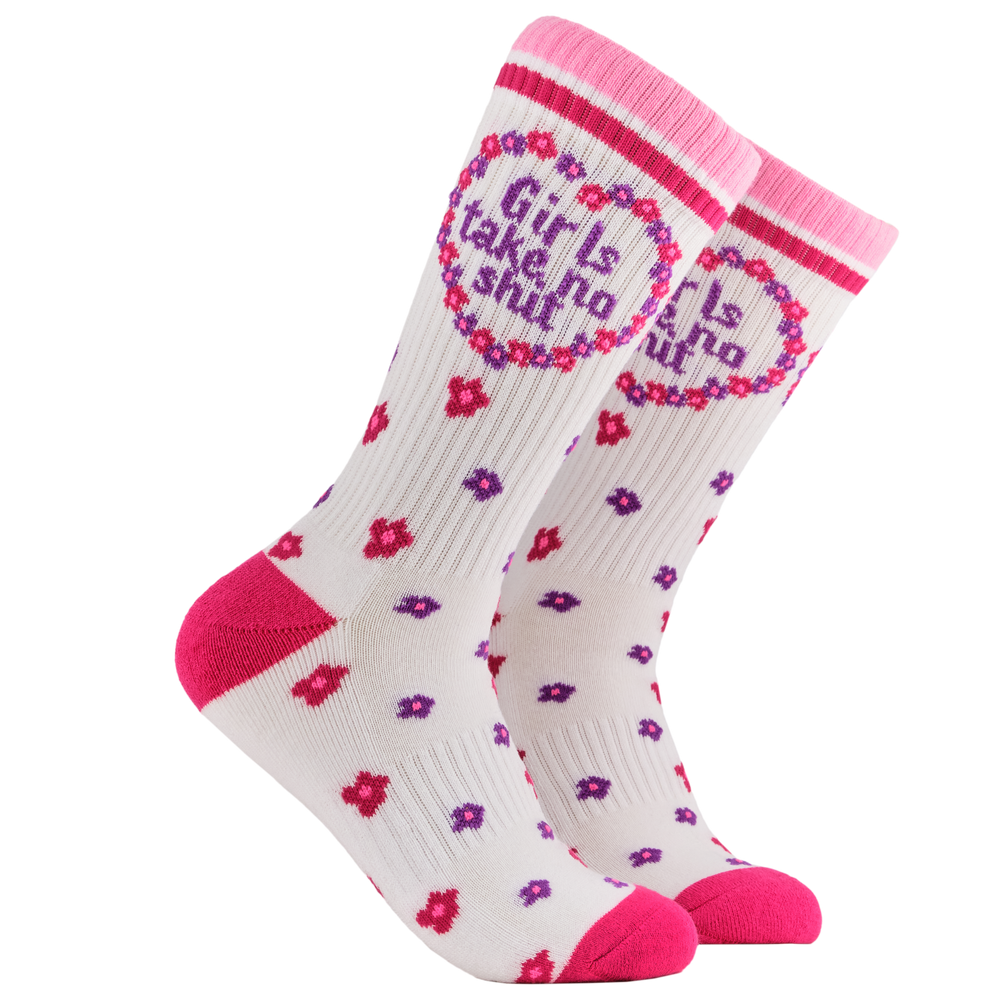 Feminist Socks - Girls Take No Shit Athletic. A pair of socks depicting the words "Girls Take No Shit". White legs, pink cuff, heel and toe.