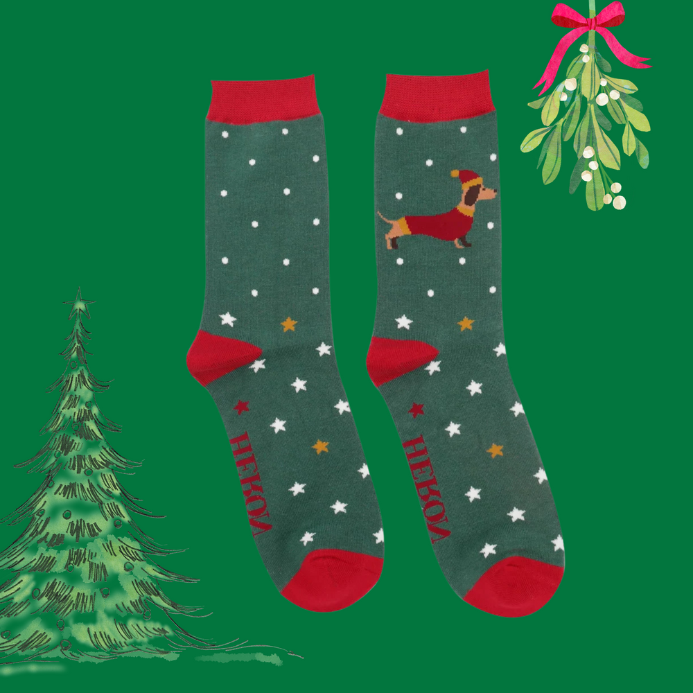 
                      
                        A pair of socks depicting a festive sausage dog with a star pattern. Green legs, red toe, heel and cuff. 
                      
                    