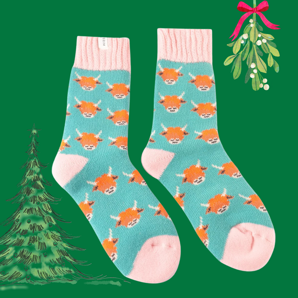 
                      
                        A pair of socks depicting highland cows. Teal legs, pink heel, toe and cuff. 
                      
                    