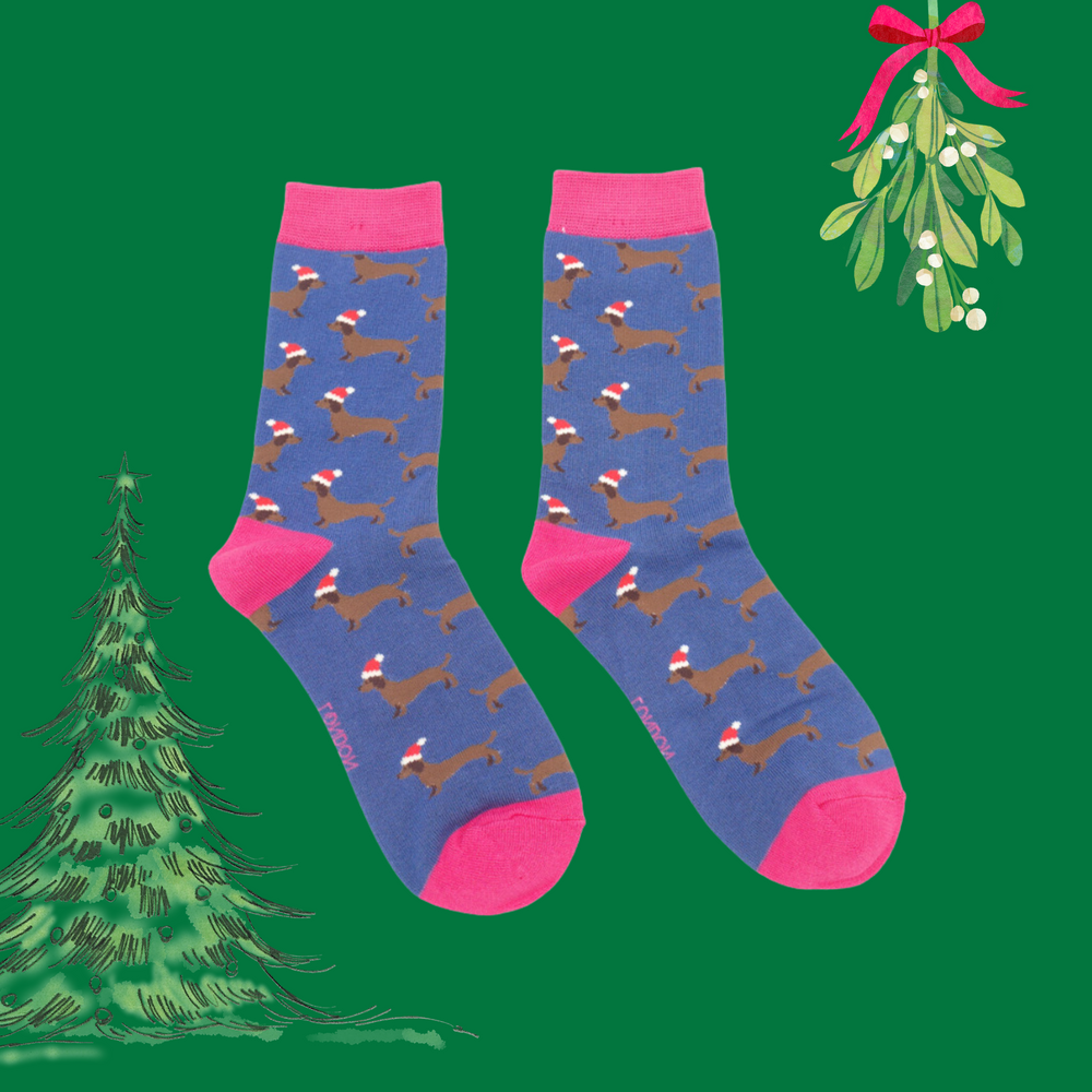 
                      
                        A pair of socks depicting sausage dogs wearing santa hats. Blue legs. Pink heel, toe and cuff. 
                      
                    