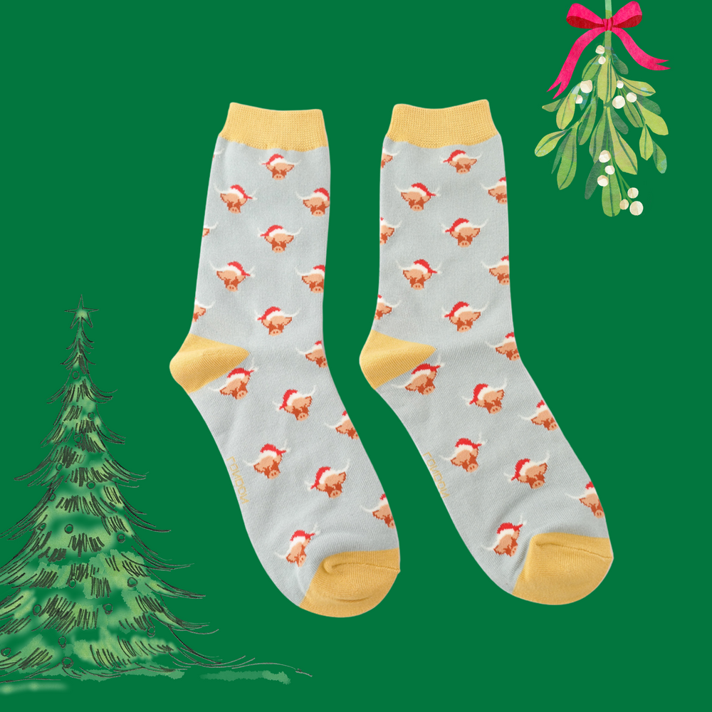 
                      
                        A pair of socks with a festive highland cow pattern. Grey legs, yellow heel, toe and cuff. 
                      
                    