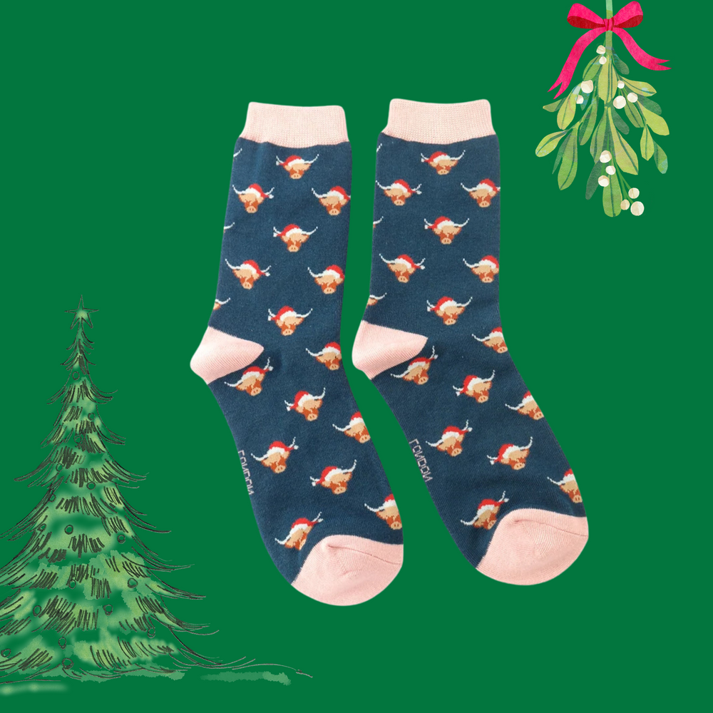 
                      
                        A pair of socks with a festive highland cow pattern. Dark blue legs, pink heel, toe and cuff. 
                      
                    