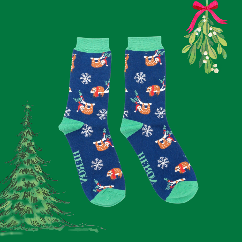 
                      
                        A pair of socks depicting xmas sloths wearing santa hats. Blue legs, green heel, toe and cuff. 
                      
                    