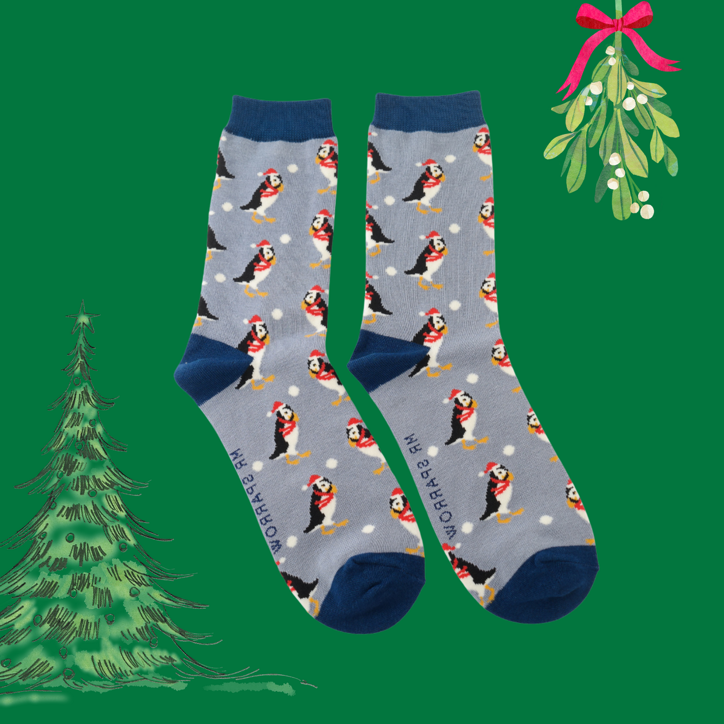 A pair of socks depicting puffins all dressed up for the holidays. Blue legs, dark blue heel, toe and cuff. 