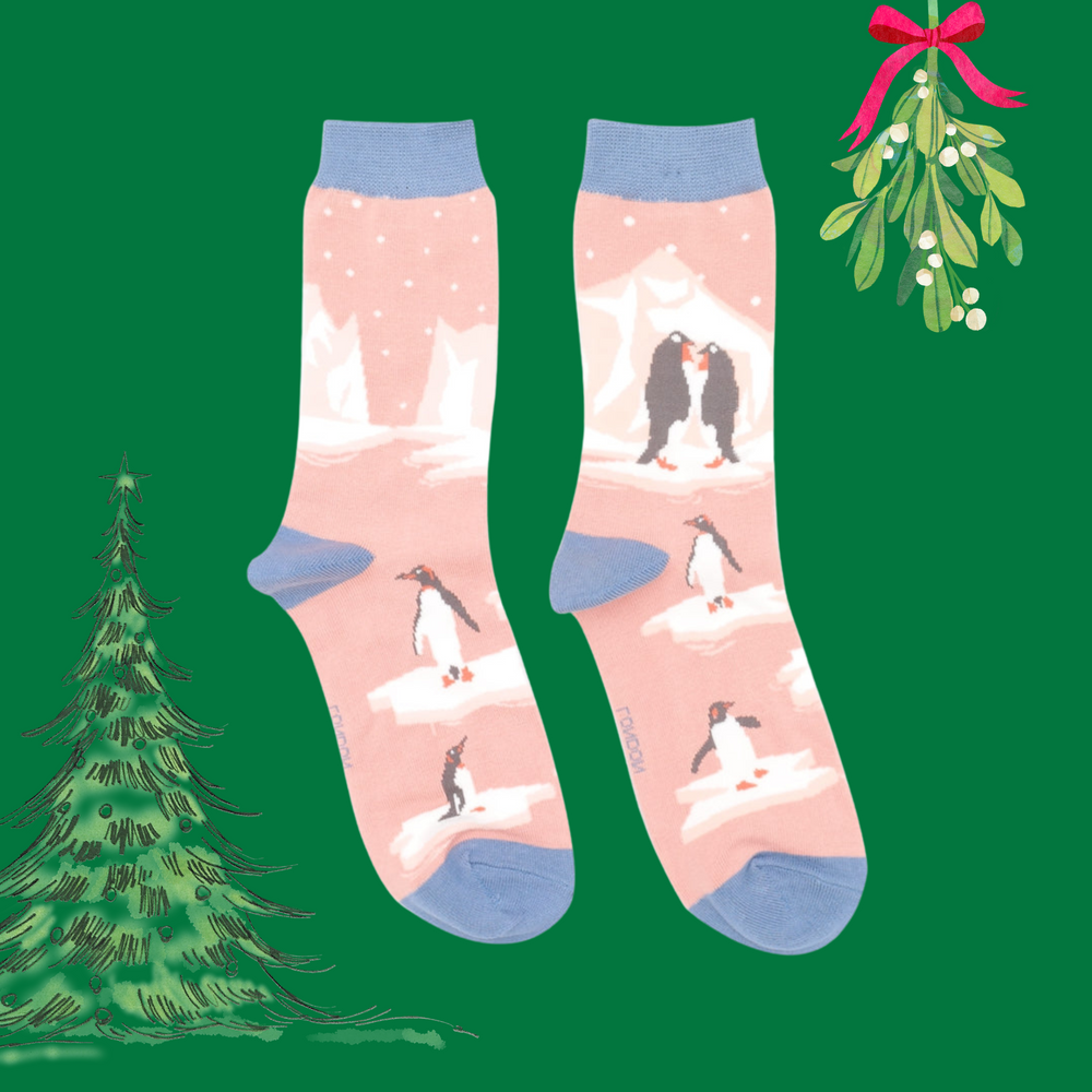 
                      
                        A pair of socks depicting penguins on ice. Pink legs. Light blue toes, heel and cuff. 
                      
                    