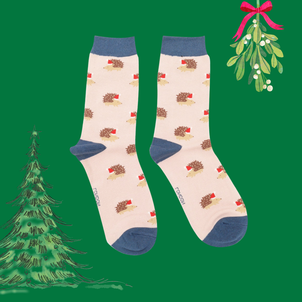 A pair of socks depicting a festive hedgehog pattern. Pink legs, blue heel, toe and cuff. 