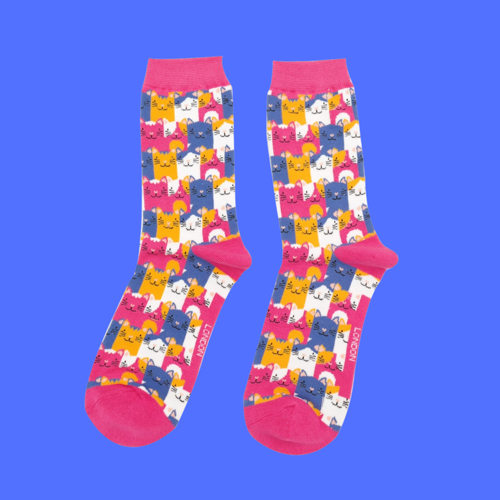 
                  
                    A pair of socks with a multicoloured happy anime cat pattern. Bright pink heel, toe and cuff.
                  
                