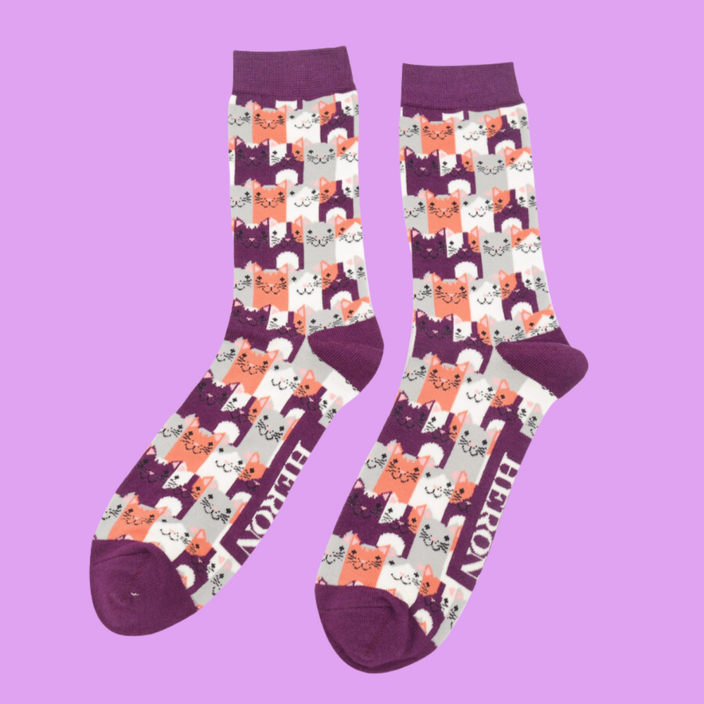 
                  
                    A pair of socks with a multicoloured happy anime cat pattern. Purple heel, toe and cuff.
                  
                