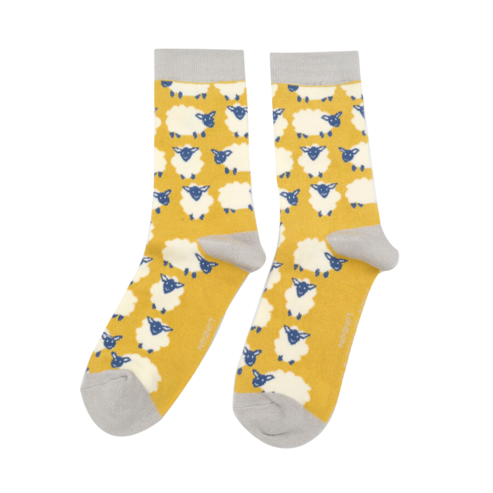 
                  
                    A pair of socks depicting happy sheep. Yellow legs, grey heel, toe and cuff.
                  
                