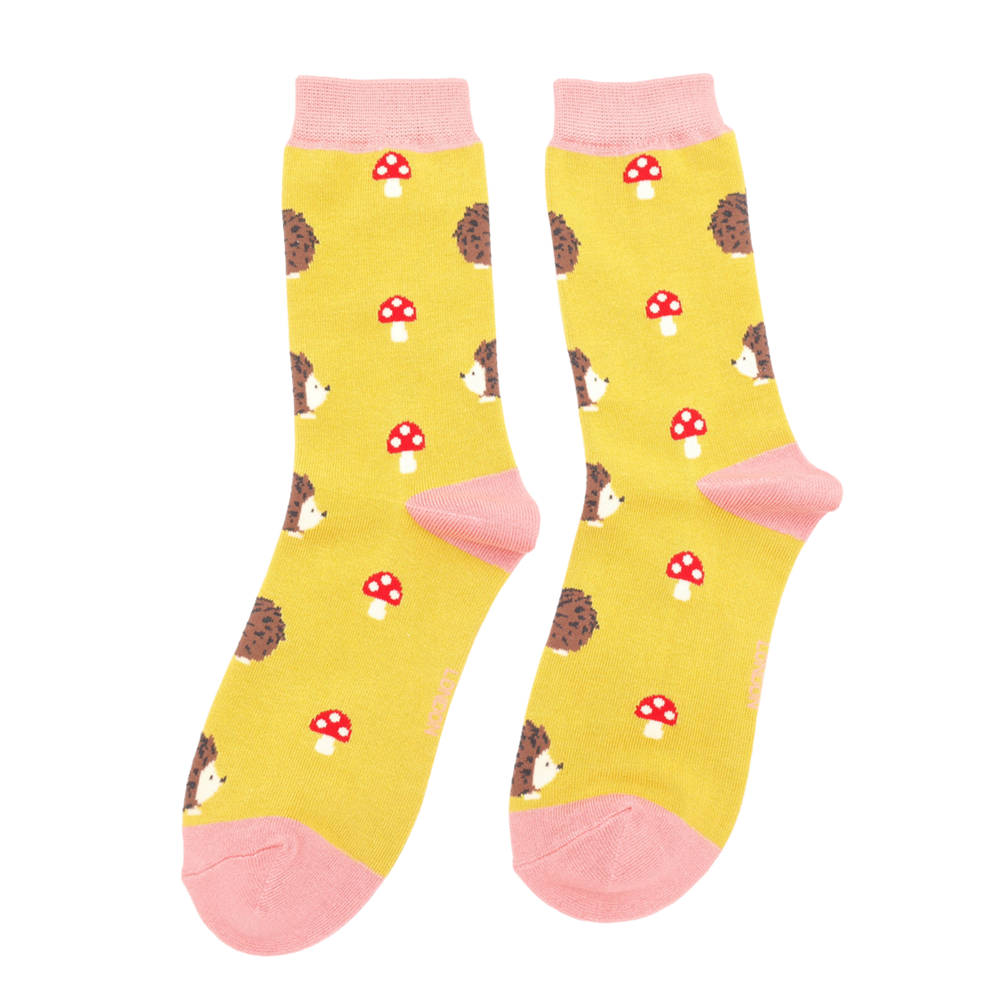 
                      
                        A pair of socks depicting hedgehogs and toadstools. Yellow legs, pink heel, toe and cuff.
                      
                    