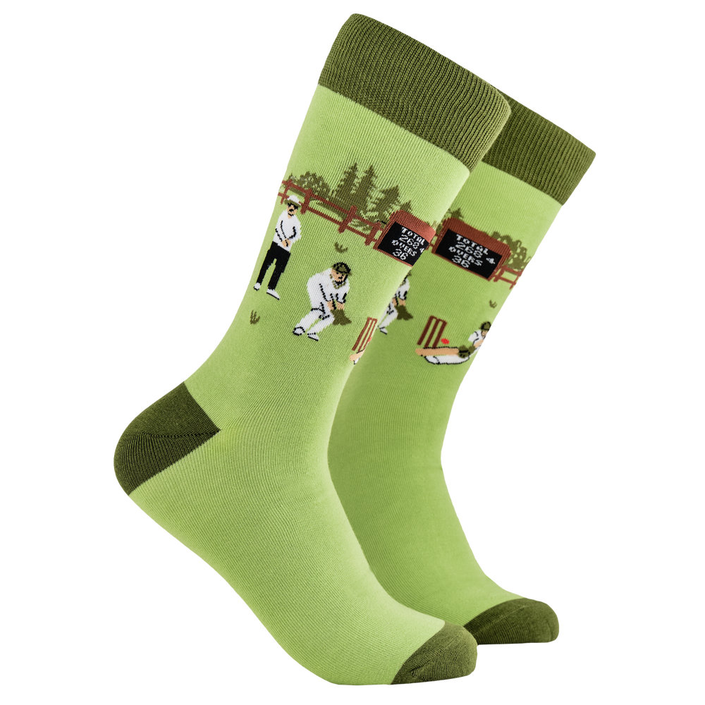 Cricket Socks - HOWZAT? A pair of socks depicting a cricket match. Green legs, dark cuff, heel and toe.