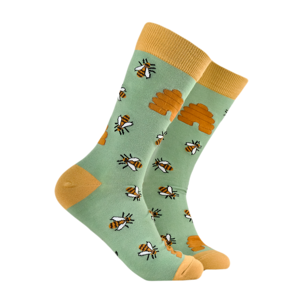 
                      
                        Honey Bee Bamboo Socks. A pair of socks featuring honey bees. Green legs, yellow heel, toe and cuff. 
                      
                    