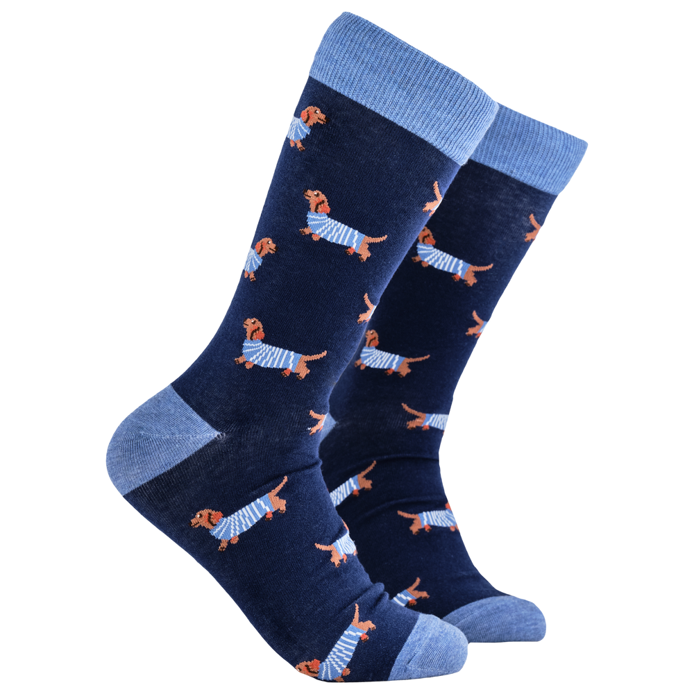 Sausage Dog Socks - Hot Dippity-Dog. A pair of socks depicting sausage dogs wearing jumpers. Dark legs, light blue cuff, heel and toe