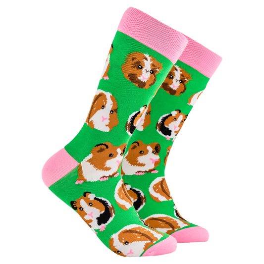 Guinea Pig Socks - I Am Not A Hamster. A pair of socks depicting guinea pigs. Green legs, pink cuff, heel and toe. 