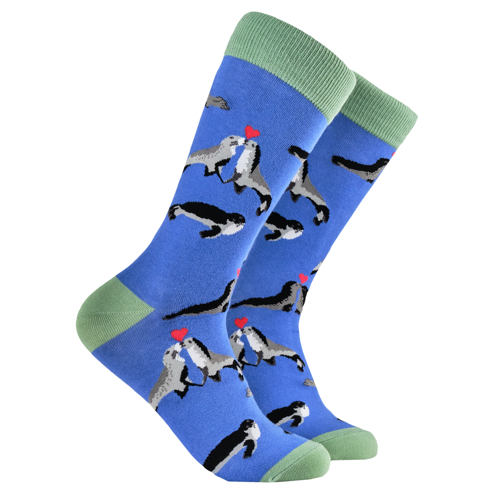 Kissing Seals Socks. A pair of socks depicting two seals in love. Blue legs, green heel, toe and cuff. 